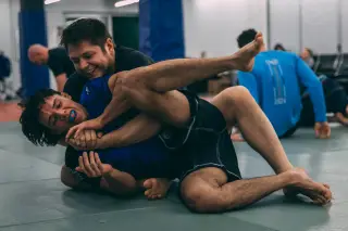 Justin adjusting a student's posture during a sparring round